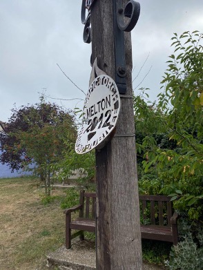 Damaged roundel on village sign