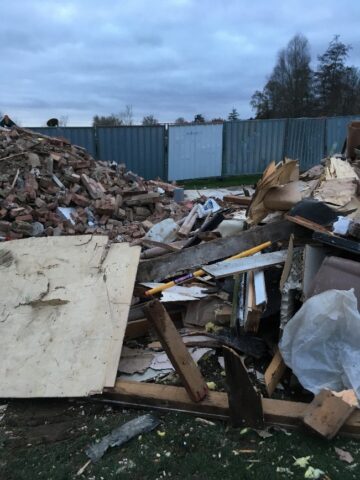 This picture shows the rubble piled ready to go into huge skips.