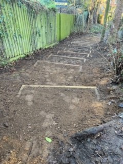 This picture shows the steps on the footpath behind Saxon Way edged in wood.