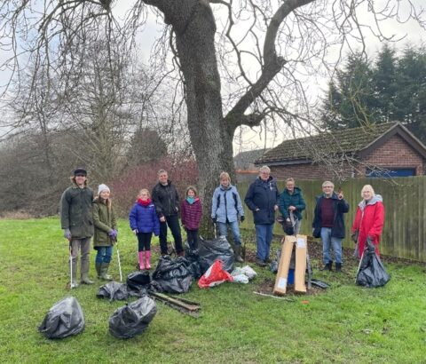 This photo shows the Melton Womblers litter picking group standing with the bags of rubbish they have collected.