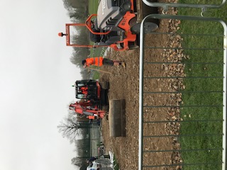 Contractors laying temporary road surface 