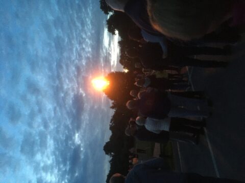 People gathered to view the lit beacon.