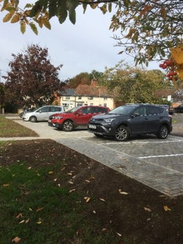 Paved parking bays with 3 parked cars