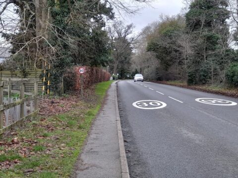 Road with white painted 30mph roundels on road surface